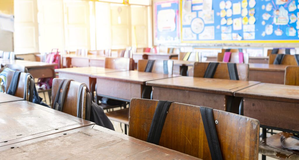 Empty classroom with wooden desks.
