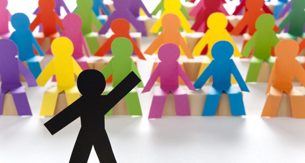 Colorful paper figures with one leader