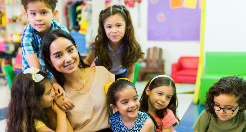 Lovely preschool teacher giving love to her students Preschool teacher