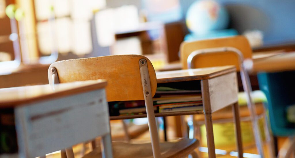 Classroom with empty wooden desks.