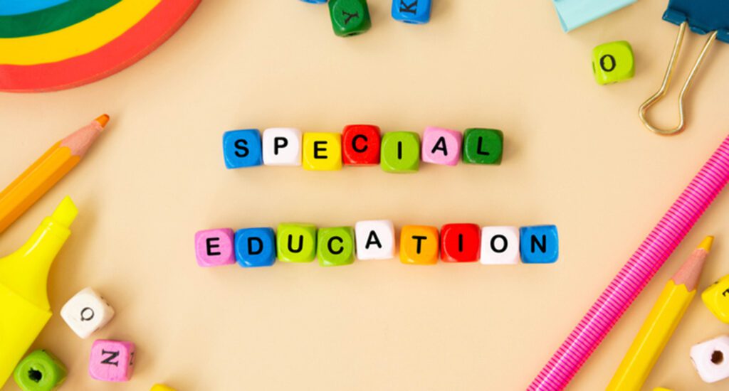Special education words, child care, disability concept. Colorful office suplies flat lay with wooden cubes. special education