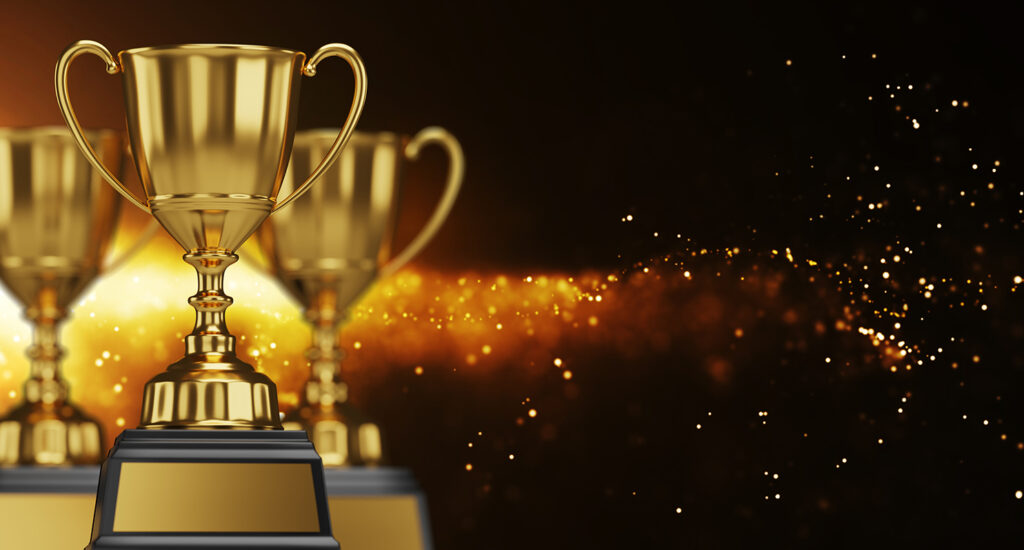 Golden trophies with sparkling background.