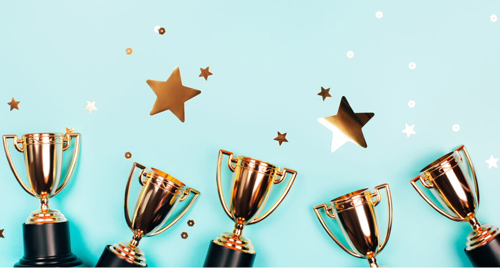 Trophies and stars on blue background.