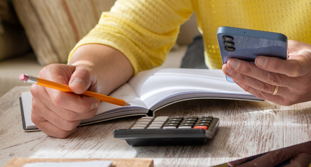 Woman Setting Financial Goals at Home. Calculator Finance Budget