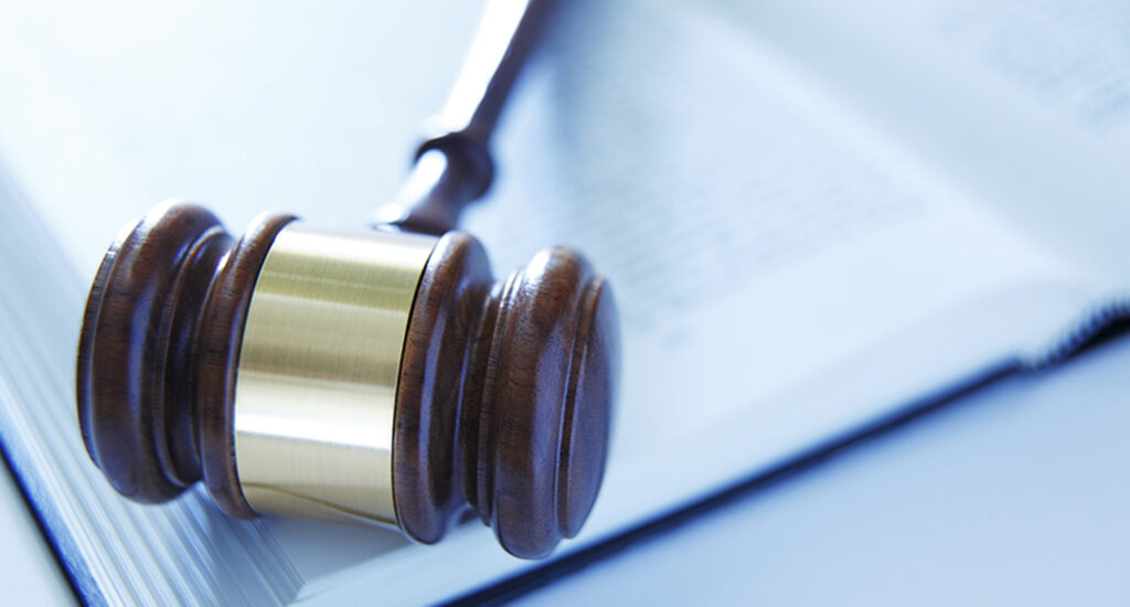 Wooden gavel on open book.