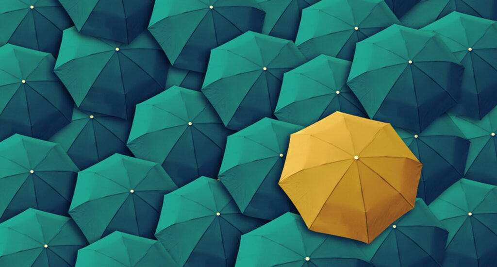Yellow umbrella among teal umbrellas.