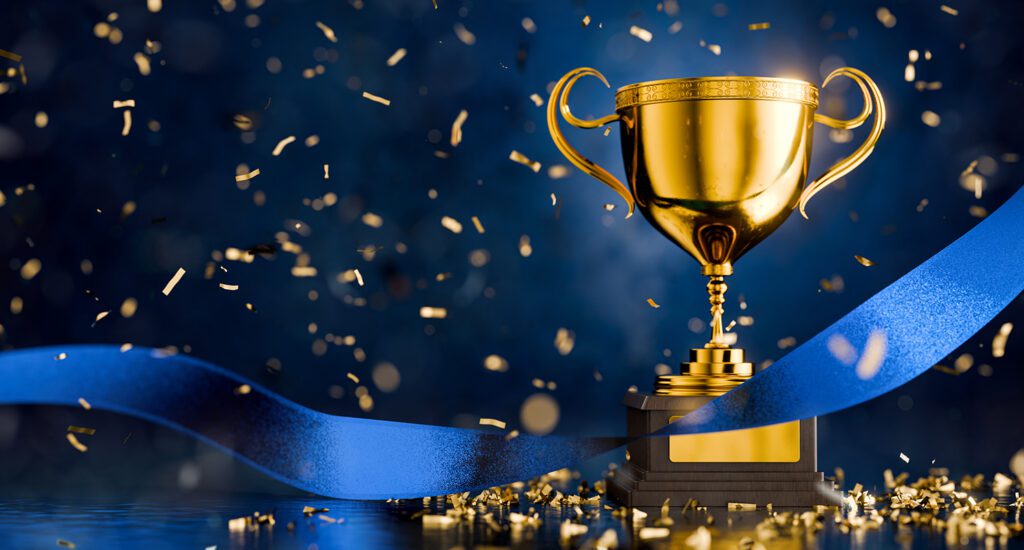 Golden trophy on a blue background with a blue ribbon and gold confetti.
