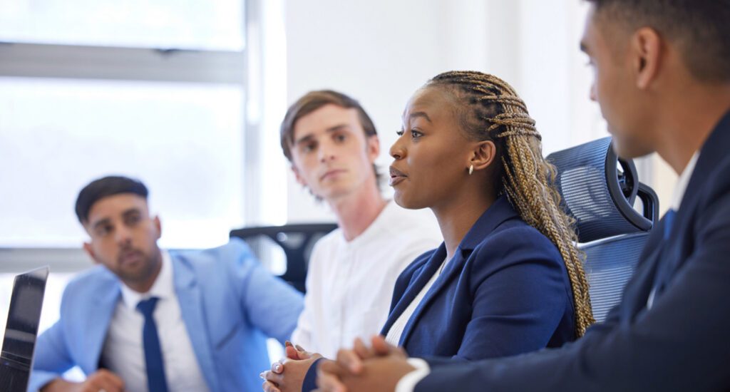 Young professionals listening to one of them present.