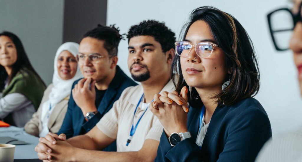 People listening to a presentation around a conference table.