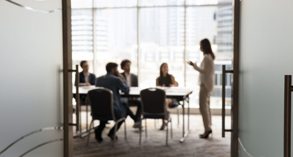 Businesspeople engaged around a conference table.