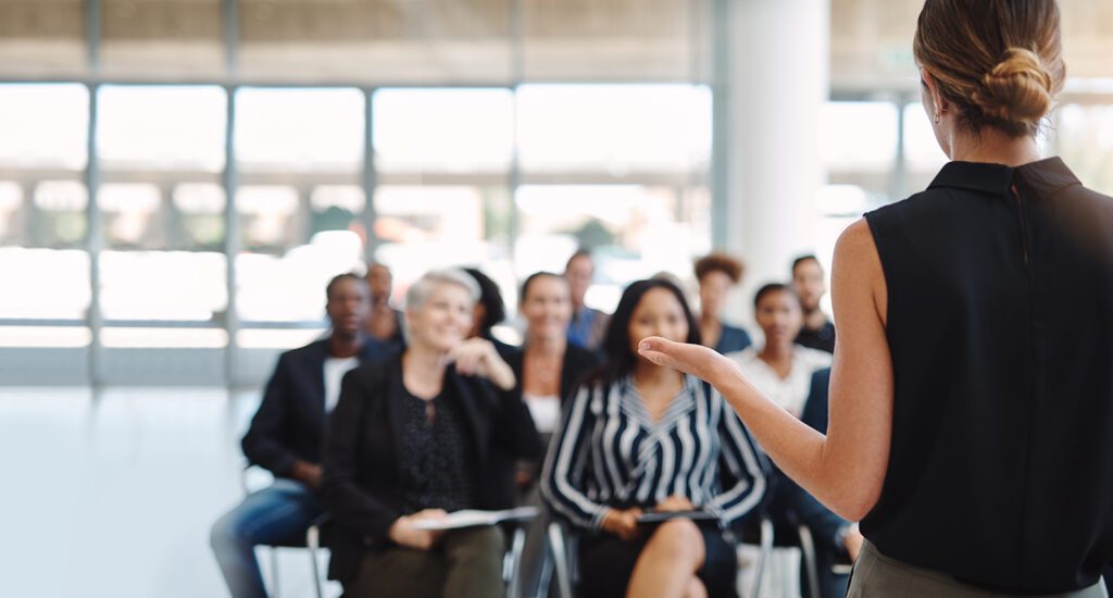 Woman presenting at a meeting or event.